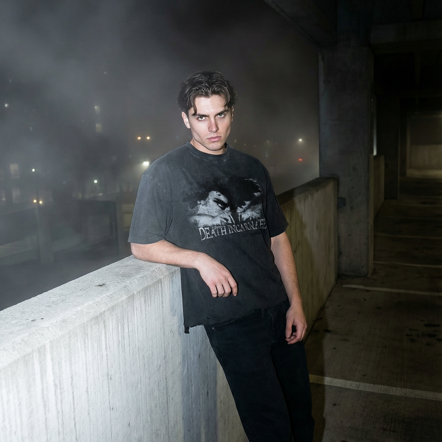 Person leaning against a concrete wall in an urban setting with mist