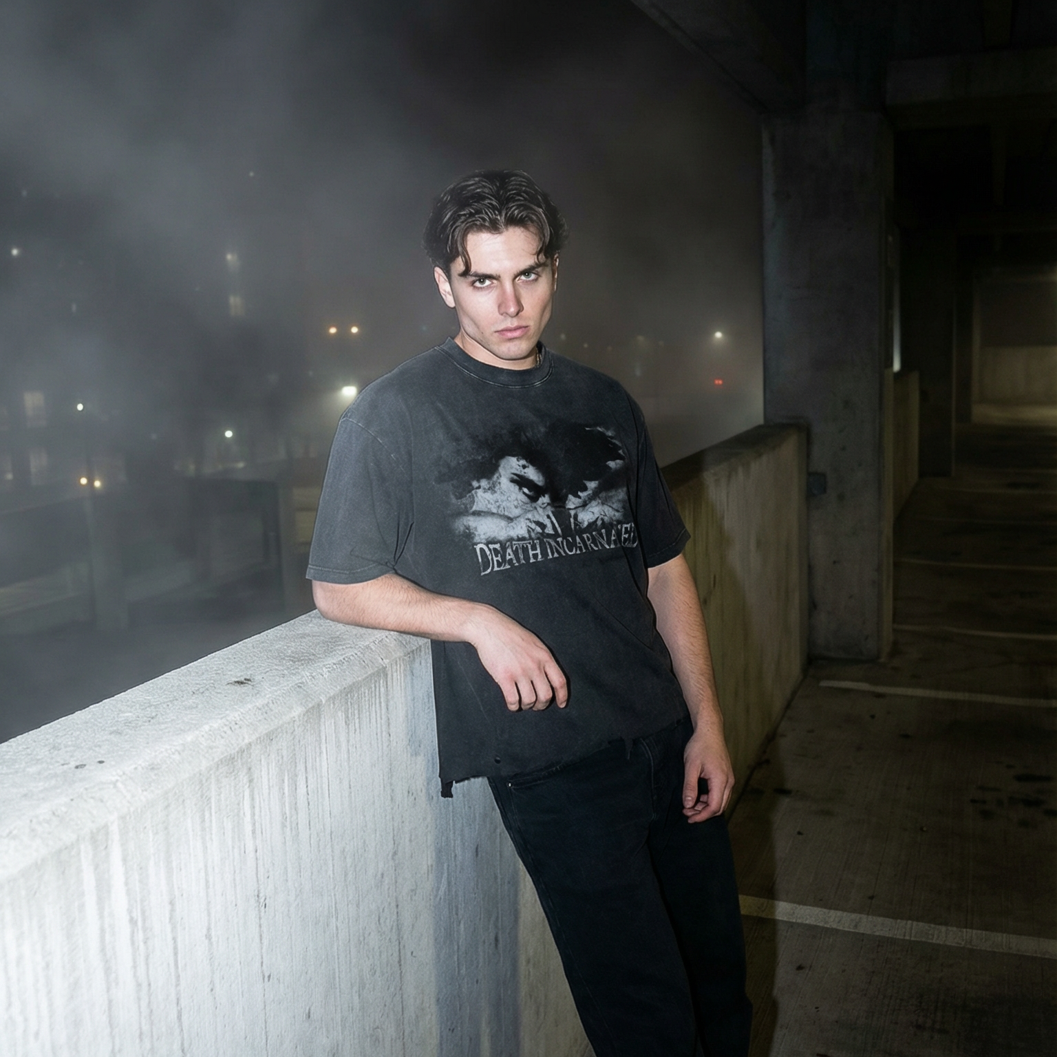 Person leaning against a concrete wall in an urban setting with mist